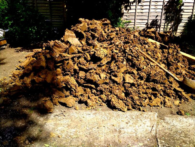 Orange-brown clay soil pile., This was a huge pile of soil …