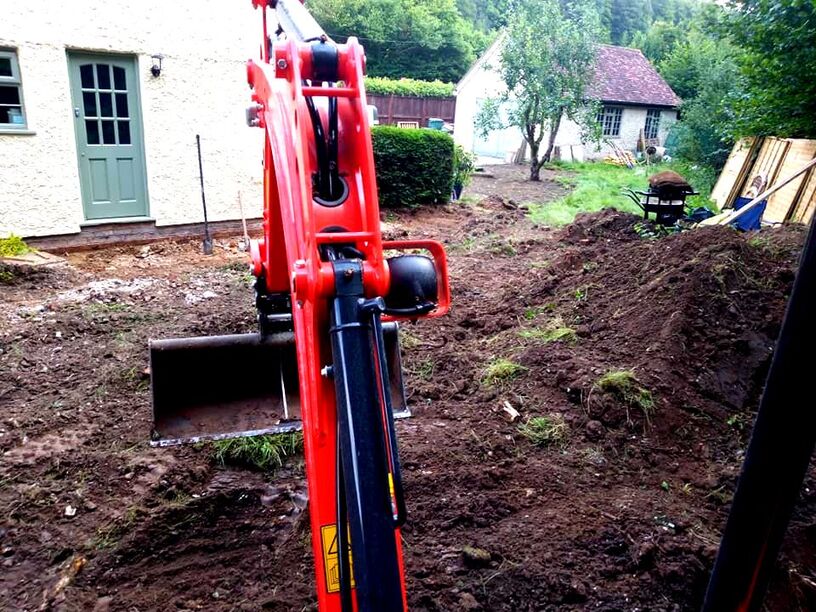 Levelling a garden with an excavator